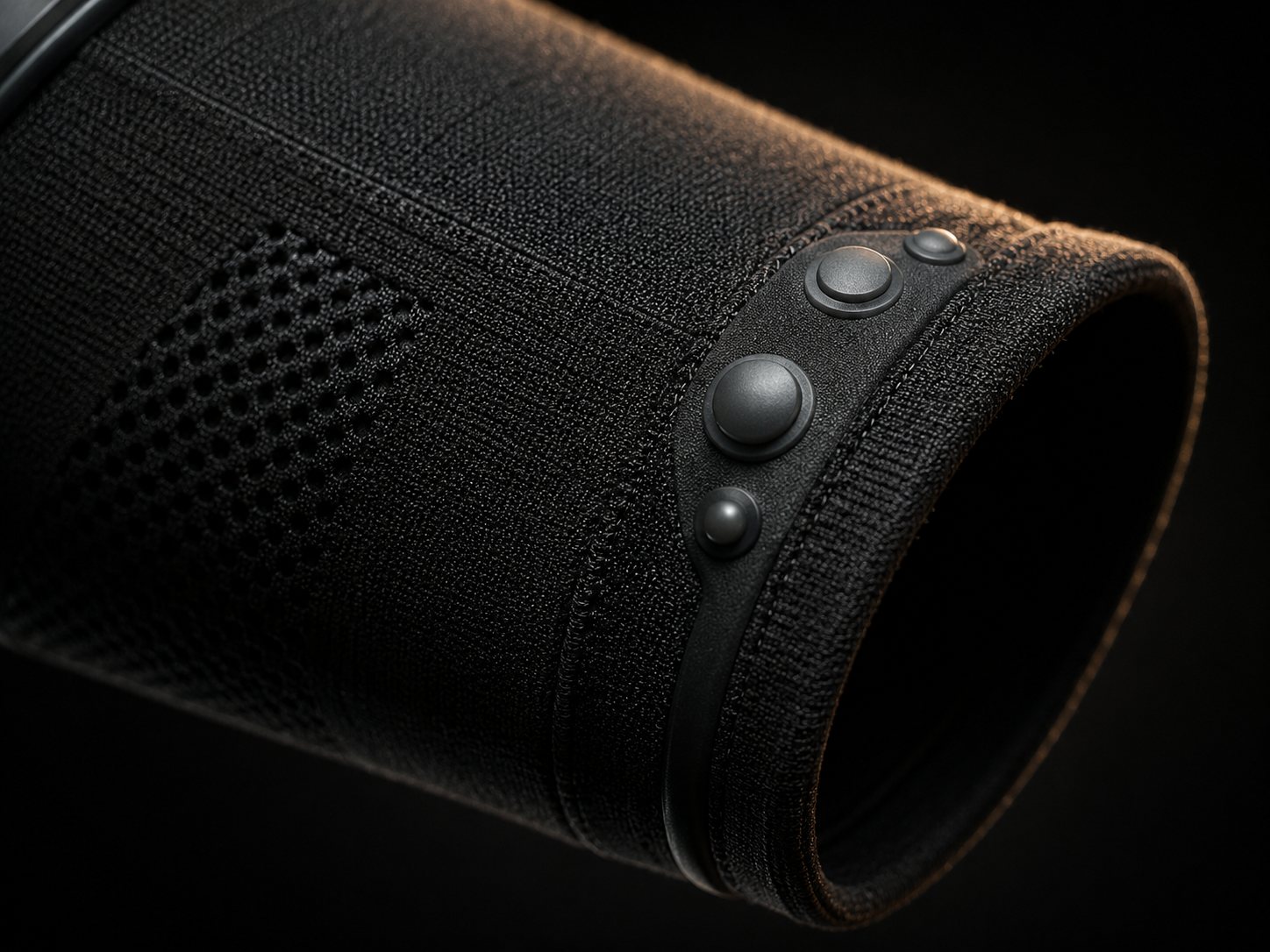 Macro of the Betta cuff: a curved row of dome haptics set into dark knit
