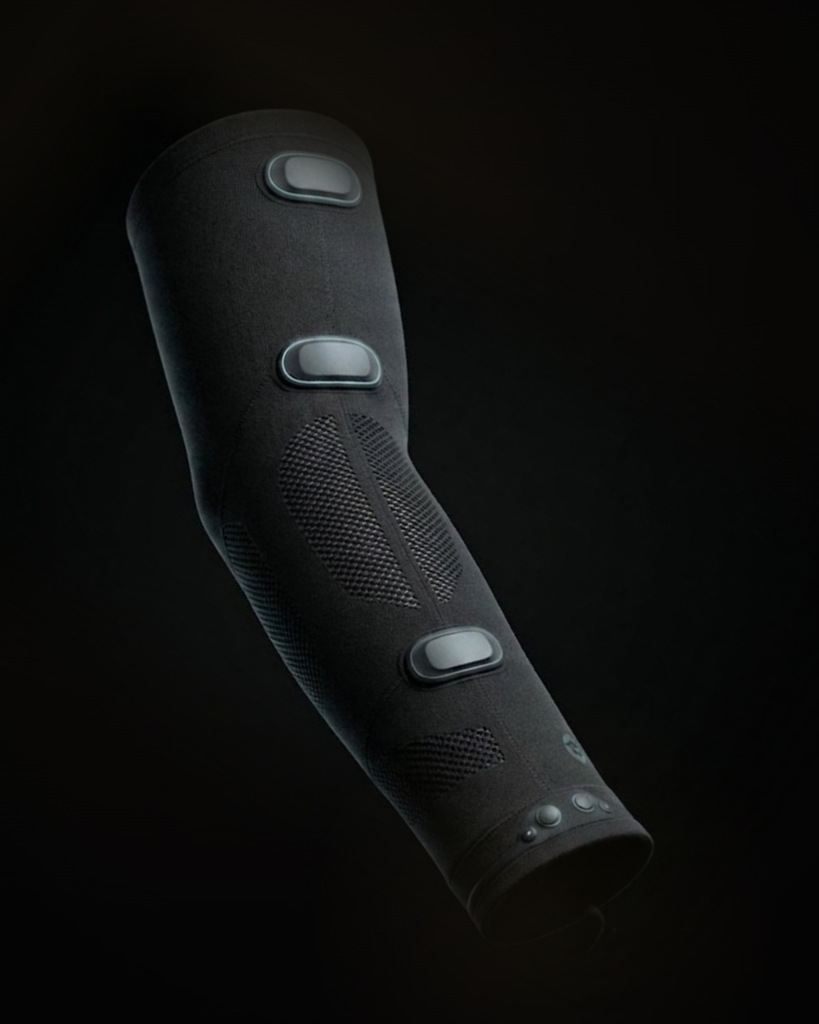 The Betta sleeve upright against a dark backdrop, three sensor pods along the arm and the studded cuff at the wrist