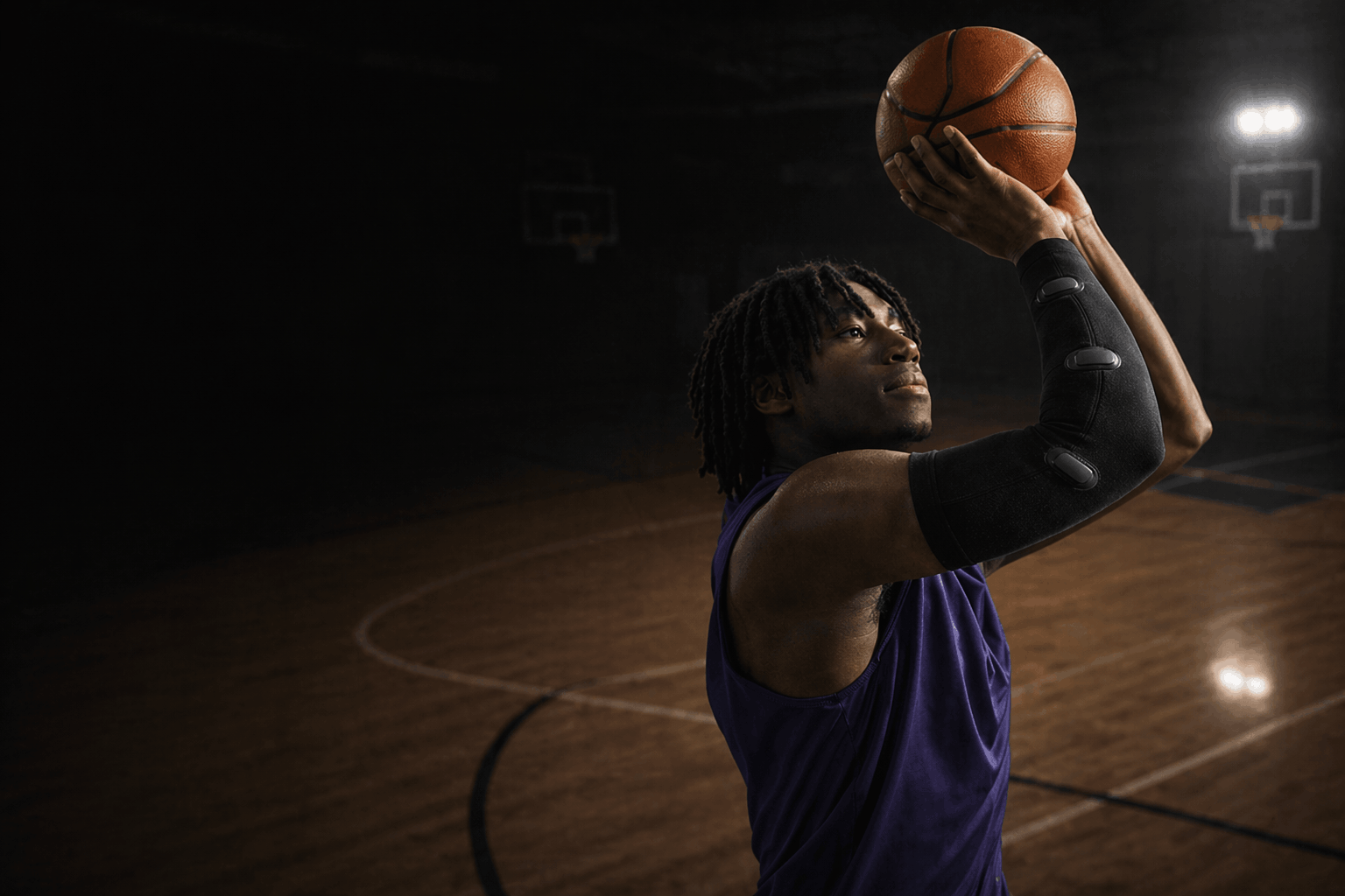 Athlete shooting a basketball wearing the Betta smart sleeve